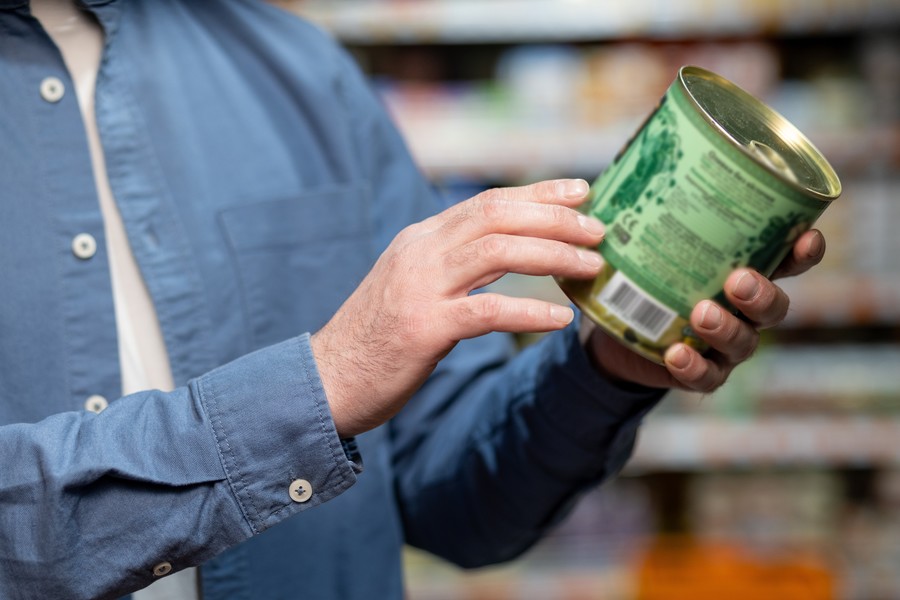 Person examining a product label.